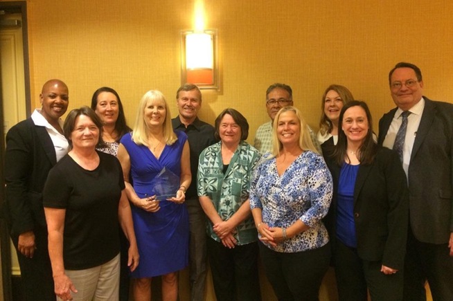 Karen Welliver (4th from left) is joined by family and friends after being inducted into the CCCWBCA Hall of Fame