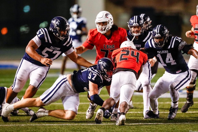 Adam Tomczyk (97) and Kevonte' Henry (14) each finished with eight tackles against LB City
