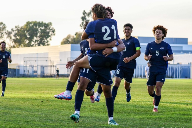 Jose Lopez (21) leaps into the arms of Pedro Reyes (11) after scoring against Mt. San Antonio