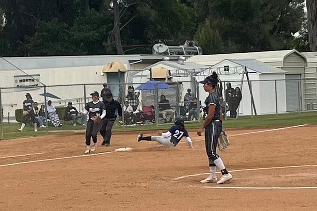 Jazmine Macias (27) slides into third base with her school-record 49th stolen base of the season