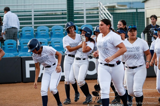 The Falcons celebrate with Marley Manalo (9), who just hit a grand slam.
