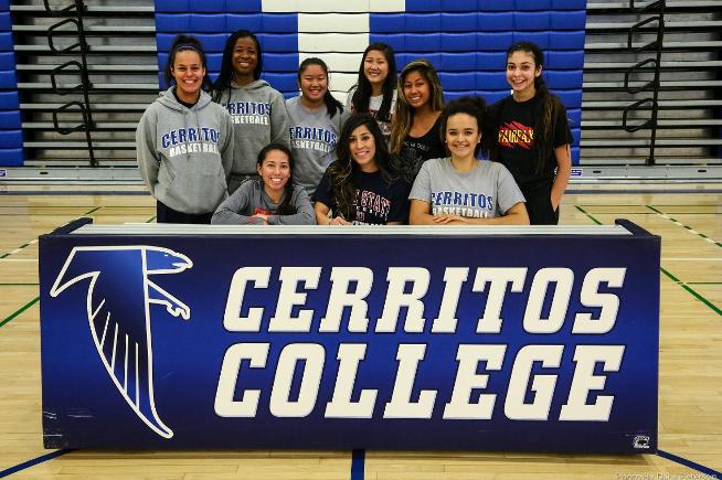 Cassidy Carrillo (seated, middle) is surrounded by her teammates after signing her NLI with Dixie State