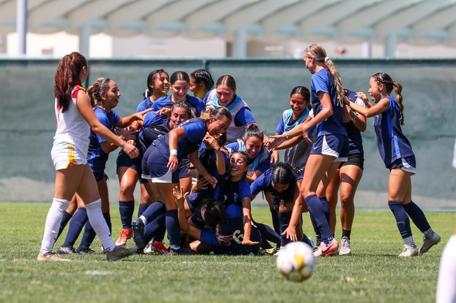 The Falcons women's soccer team celebrate after the game-winning goal by Ariana Rivera (5)